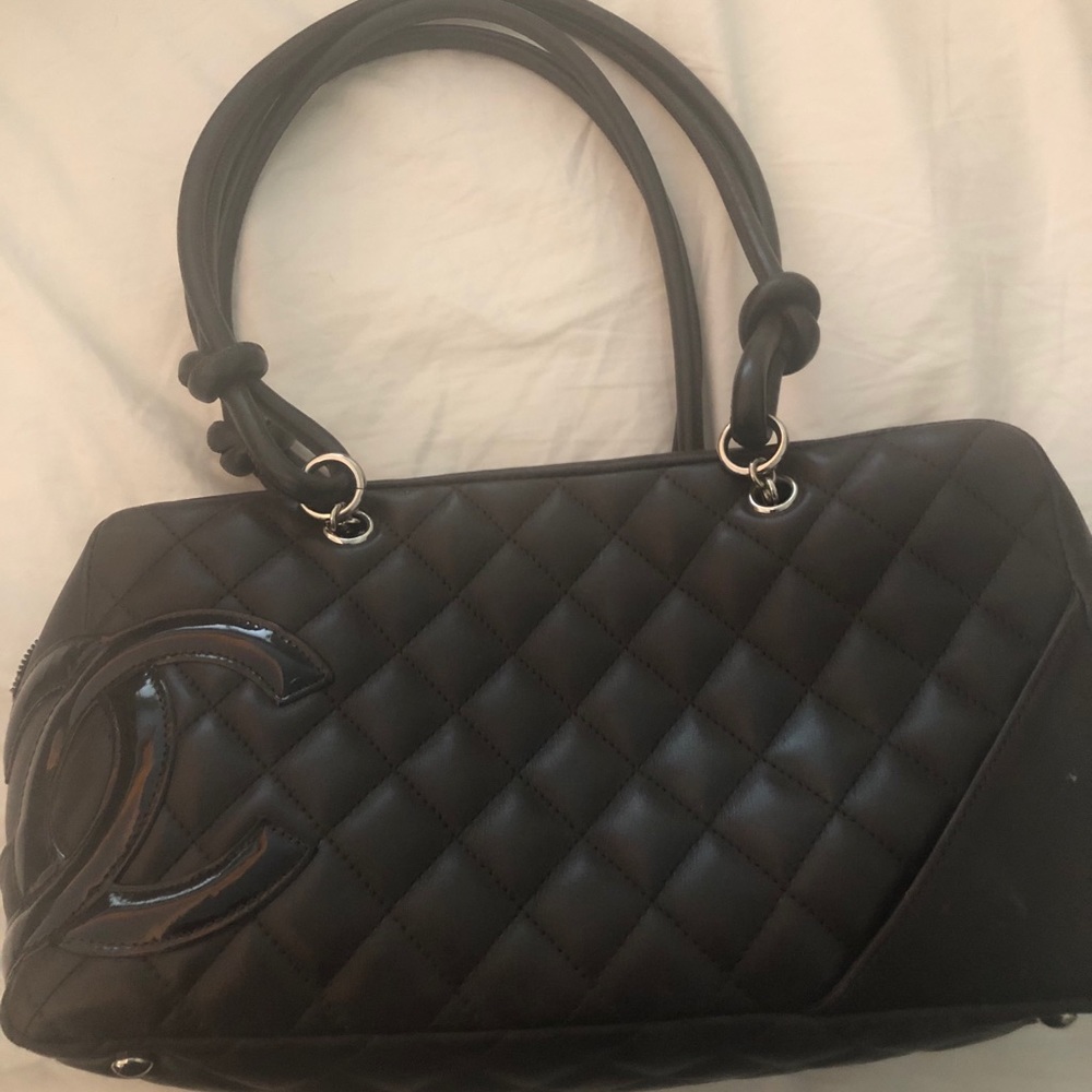 Dark brown Chanel small shoulder duffle.